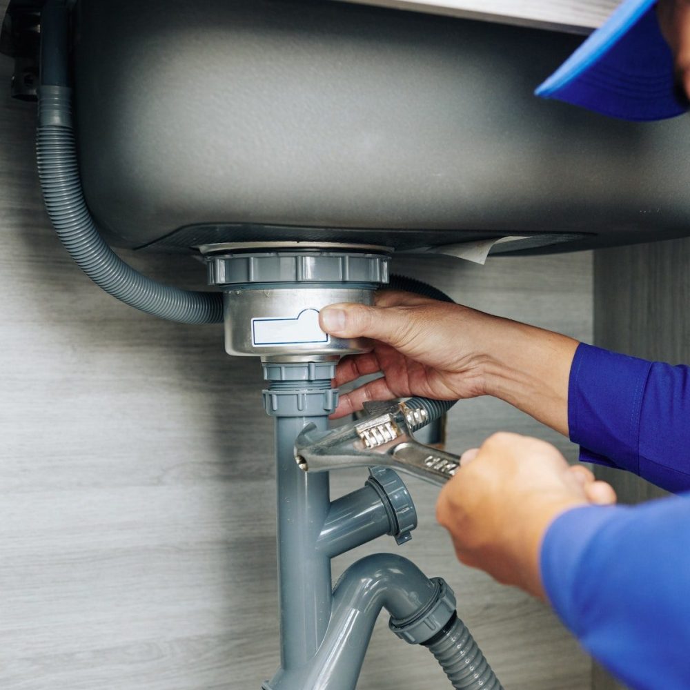 plumber-repairing-a-leaky-drain.jpg